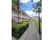 Exterior view of a condo building with multiple balconies and staircase access at 8300 Bardmoor Blvd # 110, Seminole, FL 33777