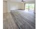 Open-plan living area with access to patio doors and new flooring throughout at 8300 Bardmoor Blvd # 110, Seminole, FL 33777