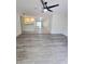 Open-concept living room with modern flooring and seamless flow into the kitchen at 8300 Bardmoor Blvd # 110, Seminole, FL 33777