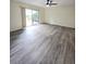 Spacious living room featuring sliding doors with outside views and new flooring at 8300 Bardmoor Blvd # 110, Seminole, FL 33777