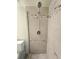 A close up of the neutral-tiled shower with a handheld shower head at 8300 Bardmoor Blvd # 110, Seminole, FL 33777