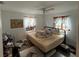 Standard bedroom with a ceiling fan, windows, and minimal decor showcasing potential at 8606 N 9Th St, Tampa, FL 33604