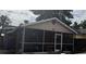 Charming screened front porch with a brick facade offering a relaxed outdoor living space at 8606 N 9Th St, Tampa, FL 33604