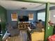 Cozy living room with natural light, comfortable seating, and a television at 8606 N 9Th St, Tampa, FL 33604