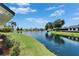Beautiful backyard with picturesque lake views, lush greenery, and well-maintained landscaping at 916 48Th Street E Dr, Bradenton, FL 34208