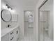 Updated bathroom showcasing a modern vanity and a view from the arched window at 916 48Th Street E Dr, Bradenton, FL 34208