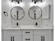 Bathroom with a double vanity, modern fixtures, and round mirrors at 916 48Th Street E Dr, Bradenton, FL 34208