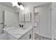 Bathroom featuring vanity with marble counter, black fixtures, and view into hallway at 916 48Th Street E Dr, Bradenton, FL 34208