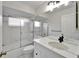 Bathroom featuring vanity with marble counter, chrome fixtures and tub with glass doors at 916 48Th Street E Dr, Bradenton, FL 34208