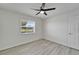 Bedroom with wood-look floors, neutral walls, ceiling fan and a window view at 916 48Th Street E Dr, Bradenton, FL 34208