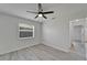 Bedroom with wood-look floors, neutral walls, ceiling fan and a window view at 916 48Th Street E Dr, Bradenton, FL 34208