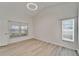 Bedroom featuring natural light from two windows and stylish wood-look floors at 916 48Th Street E Dr, Bradenton, FL 34208