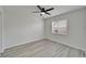 Bedroom with wood-look floors, neutral walls, ceiling fan and a window at 916 48Th Street E Dr, Bradenton, FL 34208