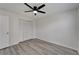 Bedroom with wood-look floors, closet and a ceiling fan with light fixture at 916 48Th Street E Dr, Bradenton, FL 34208