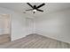 Bedroom with wood-look floors, closet, neutral walls, and ceiling fan with light fixture at 916 48Th Street E Dr, Bradenton, FL 34208