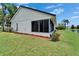 Exterior shot of a home featuring a screened lanai overlooking a picturesque lake at 916 48Th Street E Dr, Bradenton, FL 34208