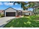 Charming home with a well-manicured lawn, inviting walkway and a two-car garage at 916 48Th Street E Dr, Bradenton, FL 34208