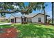 Well-manicured lawn and landscaping highlight this home's neutral paint and trim at 916 48Th Street E Dr, Bradenton, FL 34208