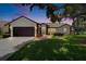Charming home with a well-manicured lawn, inviting walkway and a two-car garage at 916 48Th Street E Dr, Bradenton, FL 34208