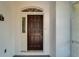 A close-up of the stylish, dark-stained front door at 916 48Th Street E Dr, Bradenton, FL 34208