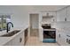 Modern kitchen boasts stainless steel appliances, sleek cabinetry, and beautiful countertop at 916 48Th Street E Dr, Bradenton, FL 34208