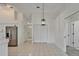 Bright kitchen with stainless steel refrigerator, and white tile floors at 916 48Th Street E Dr, Bradenton, FL 34208