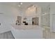 Well-lit kitchen with white cabinets, stainless appliances, quartz countertops, and convenient breakfast bar at 916 48Th Street E Dr, Bradenton, FL 34208