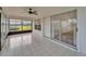 Screened lanai with tile floor and view of the lush backyard and waterfront at 916 48Th Street E Dr, Bradenton, FL 34208
