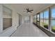 Enclosed lanai with tiled floor and multiple windows with view of the lake at 916 48Th Street E Dr, Bradenton, FL 34208
