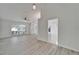 Bright living room with wood-look floors, ceiling fan, and large arched window letting in natural light at 916 48Th Street E Dr, Bradenton, FL 34208