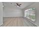 Bright living room featuring a vaulted ceiling, a ceiling fan, and a large window at 916 48Th Street E Dr, Bradenton, FL 34208