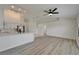 Bright, open-concept living space with modern flooring that flows into a kitchen with white cabinets at 916 48Th Street E Dr, Bradenton, FL 34208