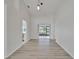 Open living space with light wood floors, sliding glass doors, and modern lighting fixtures at 916 48Th Street E Dr, Bradenton, FL 34208