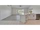 Living room with wood-look floors, kitchen island, and views of the water at 916 48Th Street E Dr, Bradenton, FL 34208