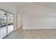 Sunlit room with sliding doors leading to a sunroom and modern flooring throughout at 916 48Th Street E Dr, Bradenton, FL 34208