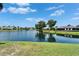 Community pond reflecting nearby houses, offering a serene and picturesque view at 916 48Th Street E Dr, Bradenton, FL 34208