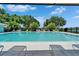 Beautiful swimming pool surrounded by lounge chairs and lush landscaping, perfect for relaxation and outdoor enjoyment at 916 48Th Street E Dr, Bradenton, FL 34208