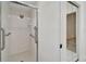 Clean shower with bright white tiling, a glass door, and chrome fixtures at 916 48Th Street E Dr, Bradenton, FL 34208