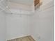 Spacious walk-in closet with organized shelving and wood-look floors at 916 48Th Street E Dr, Bradenton, FL 34208
