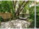 Secluded backyard patio featuring a hammock, mature trees, and a privacy fence at 945 Hamilton Ct, Palm Harbor, FL 34683