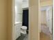 A well-lit bathroom with a gray tile floor and white cabinets is seen from the doorway at 945 Hamilton Ct, Palm Harbor, FL 34683