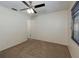 Carpeted bedroom with a ceiling fan and a window that allows natural light at 945 Hamilton Ct, Palm Harbor, FL 34683