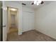Bedroom with neutral carpet and paint, featuring a ceiling fan and closet space at 945 Hamilton Ct, Palm Harbor, FL 34683