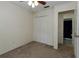 Bedroom with neutral carpet and paint, features a ceiling fan and closet at 945 Hamilton Ct, Palm Harbor, FL 34683