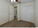 Bedroom featuring a ceiling fan, neutral carpet and paint, and access to a bathroom at 945 Hamilton Ct, Palm Harbor, FL 34683