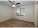 Spacious bedroom with carpeted floors, a ceiling fan, and a window allowing natural light at 945 Hamilton Ct, Palm Harbor, FL 34683