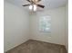Bedroom featuring a ceiling fan, neutral carpet, and a window for natural light at 945 Hamilton Ct, Palm Harbor, FL 34683