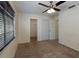 Carpeted bedroom with a ceiling fan, closet, and window that allows natural light at 945 Hamilton Ct, Palm Harbor, FL 34683