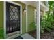 Close-up of the front door showcasing the address and design details at 945 Hamilton Ct, Palm Harbor, FL 34683