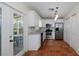 Kitchen featuring white cabinetry, stainless appliances, and convenient access to the outdoor patio at 945 Hamilton Ct, Palm Harbor, FL 34683